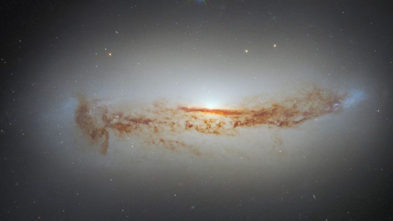 New Hubble photo shows galaxy’s bright supermassive black hole cloaked in dust_624d9ee00120f.jpeg