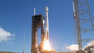 a rocket blasting off with blue sky behind