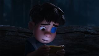 Screenshot from the animated sci-fi movie Elio. A young boy with a blue eye patch stares down at the yellow smartphone in his hands.