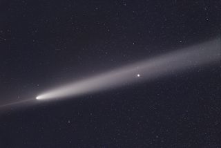 a bright white, fuzzy streak in the night sky