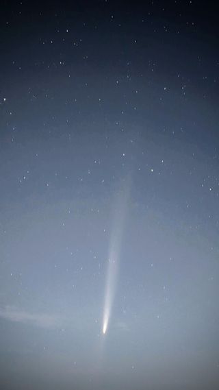 a bright white, fuzzy streak in the night sky