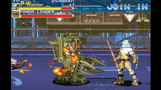 Screenshot from Alien vs. Predator (arcade), showing a human in a yellow mech suit fighting a Predator.