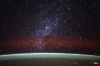 countless stars shine above the curve of earth, as seen from the international space station