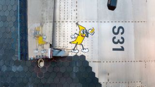 photo of a cartoon banana painted on the side of a silver spacecraft