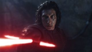 Image from the game Star Wars Knights of the Old Republic II: The Sith Lords. Close up of as very menacing Kylo Ren. He has shaggy, black hair almost down to his chin and his face is covered in dirt. He is wearing black armor and gloves and is wielding a broadsword-style lightsaber in front of him.