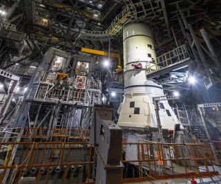 a rocket inside of a warehouse with scaffolding