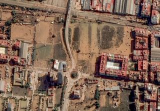 an overhead view of a roundabout surrounded by flooded buildings