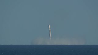 Starship's Super Heavy Flight 6 booster hovers over the Gulf of Mexico shortly before splashdown on Nov. 19, 2024.