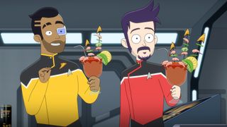 Two men in Starfleet uniforms, one yellow, one red, holding elaborate cocktails.