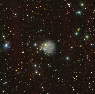 A faint smoky white blob against a black background surrounded by green, yellow, red, orbs