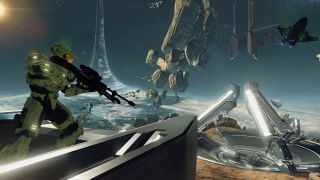 A soldier in green armor holding a sniper rifle stood on top of a metallic structure, with the Halo ringworld he's stood on extending off into the sky. There are asteroids and a purple alien spacecraft in the sky as well.