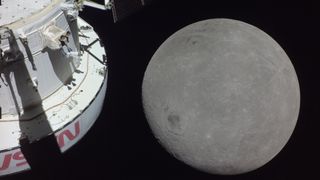 A white Artemis 1 Orion spacecraft with NASA in red letters on its side with the moon in the background