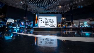 interior of a space museum, featuring a white sign that says "space center houston"